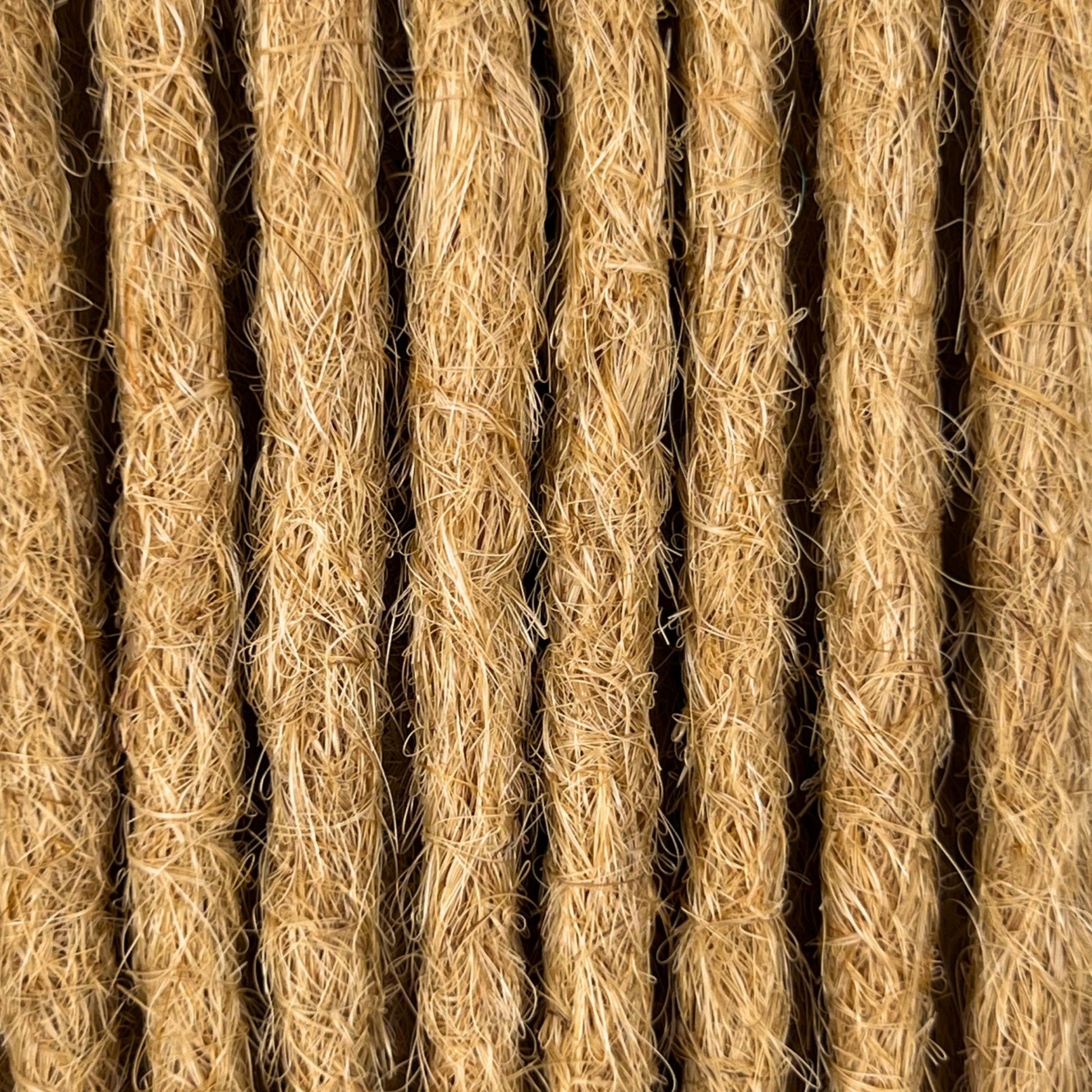 Close-up of straight loc extensions in Sunkissed Blonde, showing the texture and color.