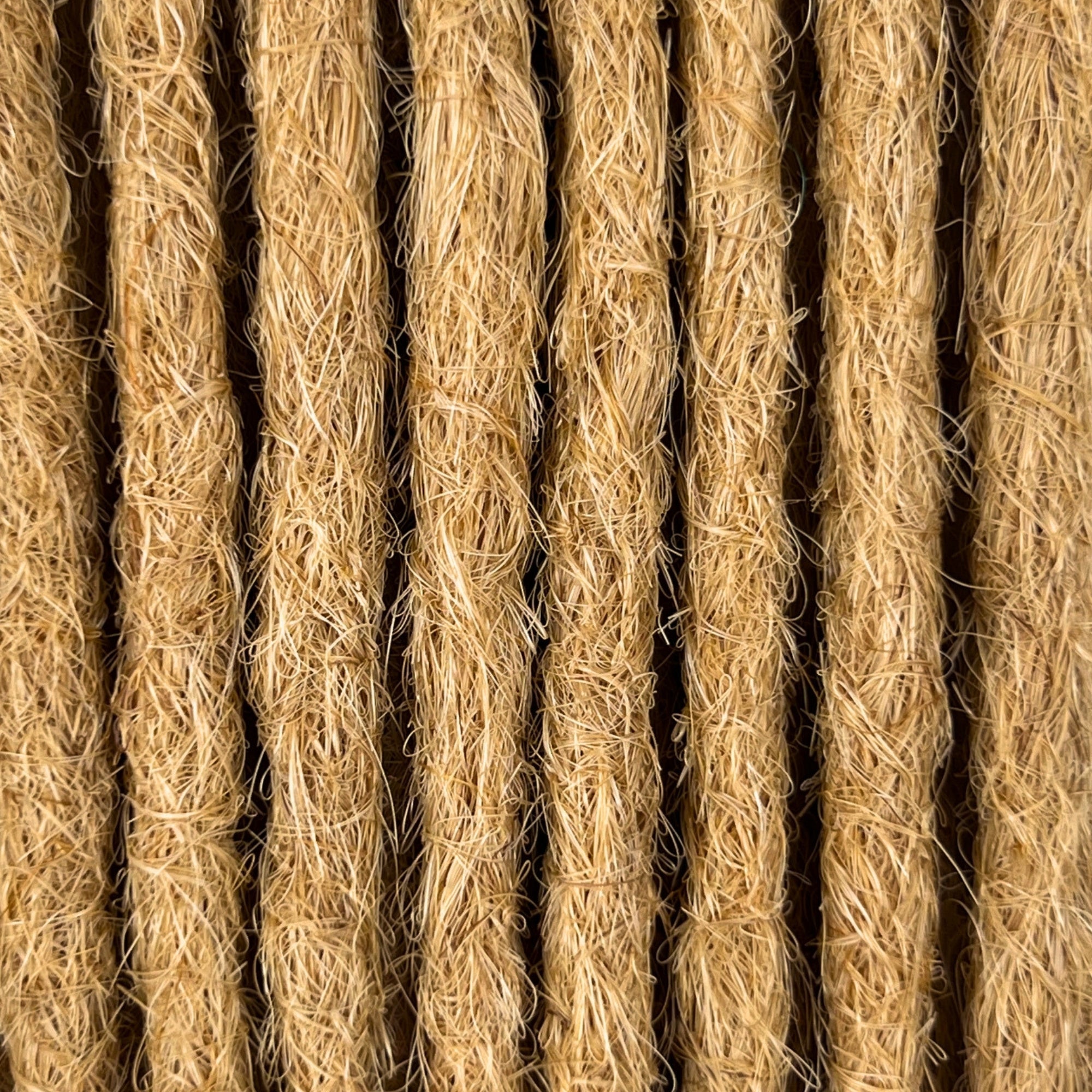 Close-up of straight loc extensions in Sunkissed Blonde, showing the texture and color.