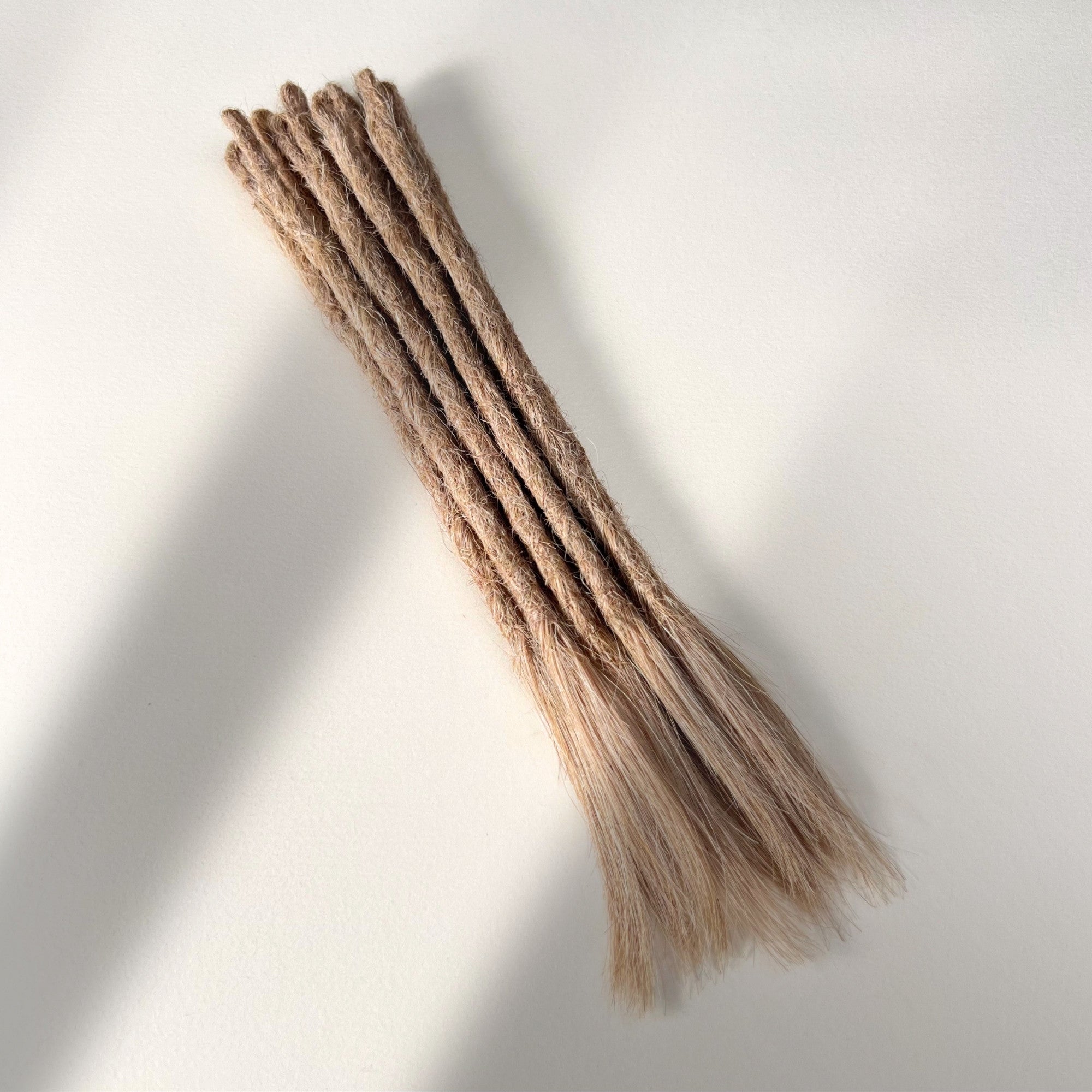 Full view of temporary single-ended straight loc extensions with open ends in Golden Blonde.