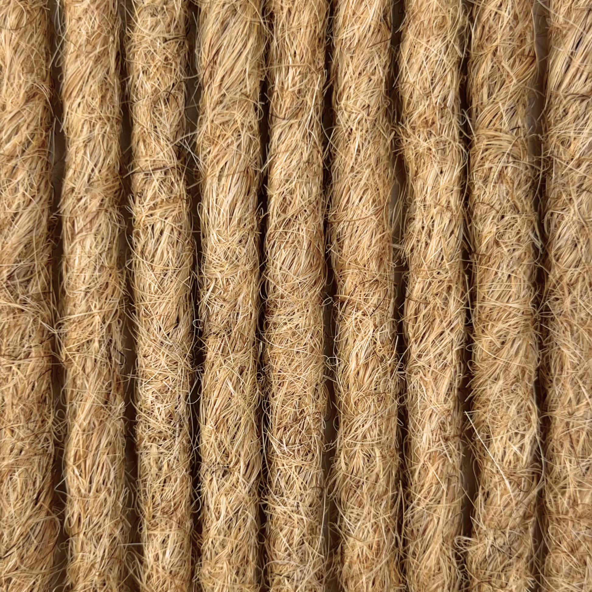 Close-up of straight loc extensions in Warm Beige Blonde, showing the texture and color.