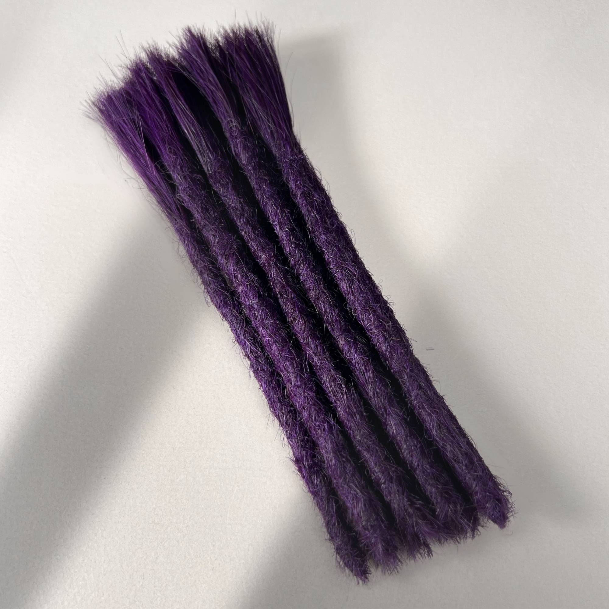 Full view of permanent straight loc extensions with blunt ends in Electric Violet.