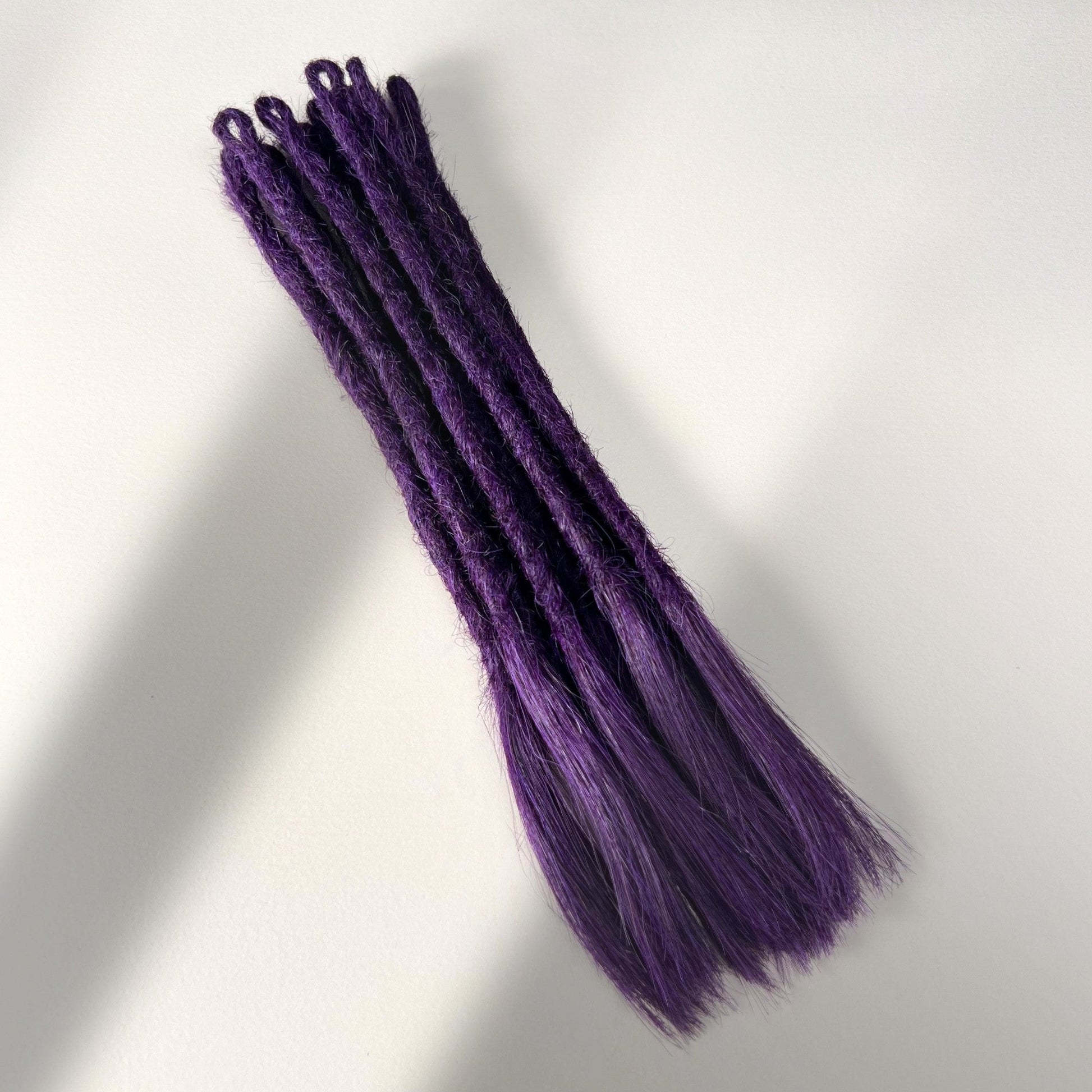 Full view of temporary single-ended straight loc extensions with open ends in Electric Violet.