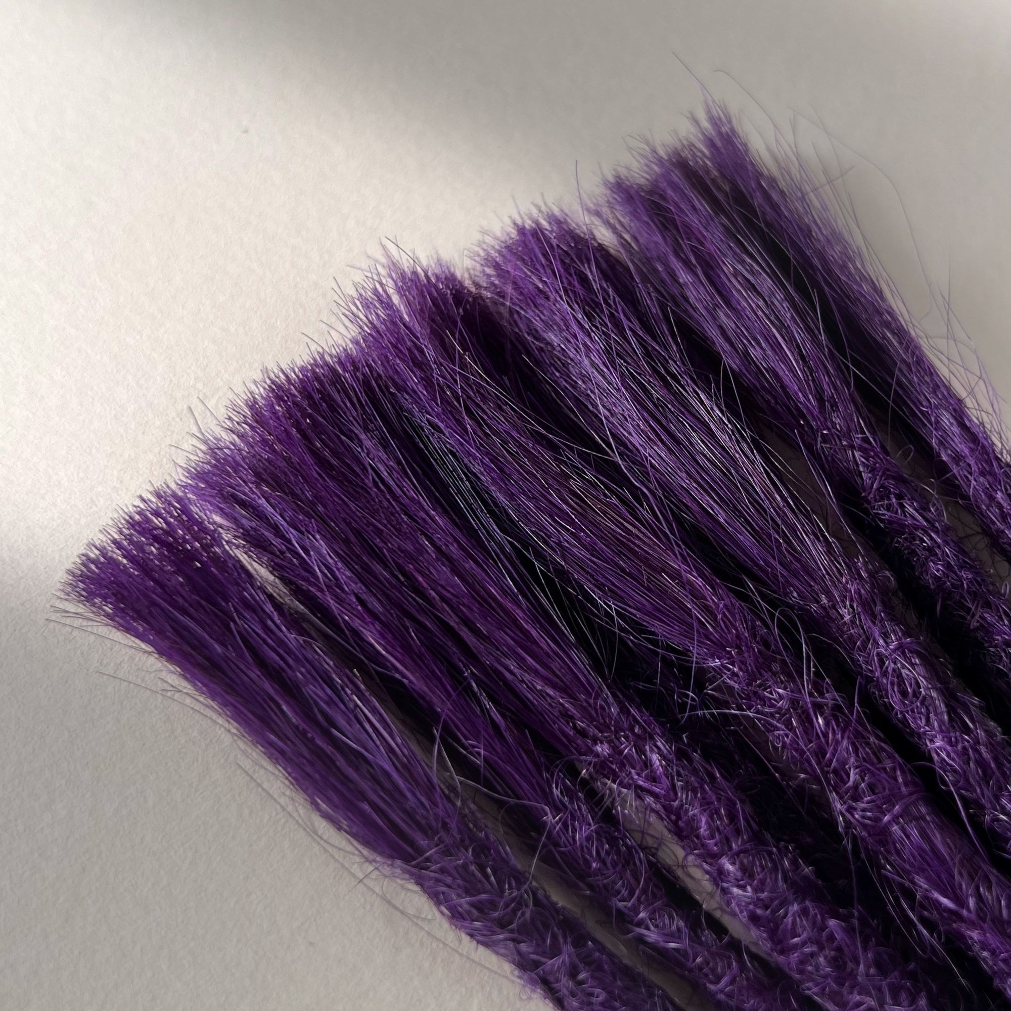 Connection point of permanent straight loc extensions in Electric Violet.