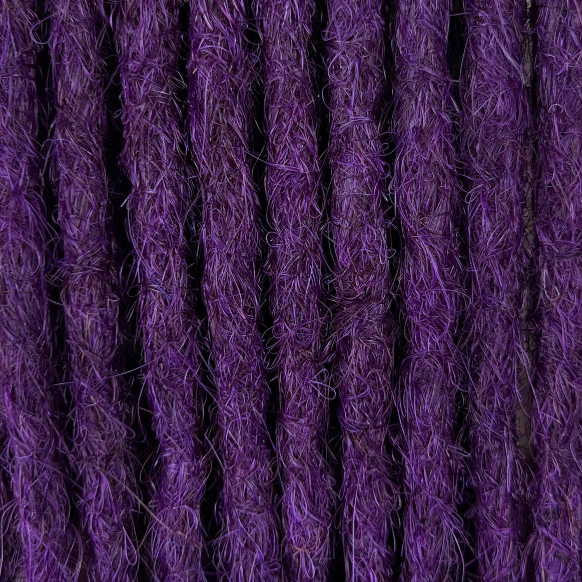 Close-up of straight loc extensions in Electric Violet, showing the texture and color.