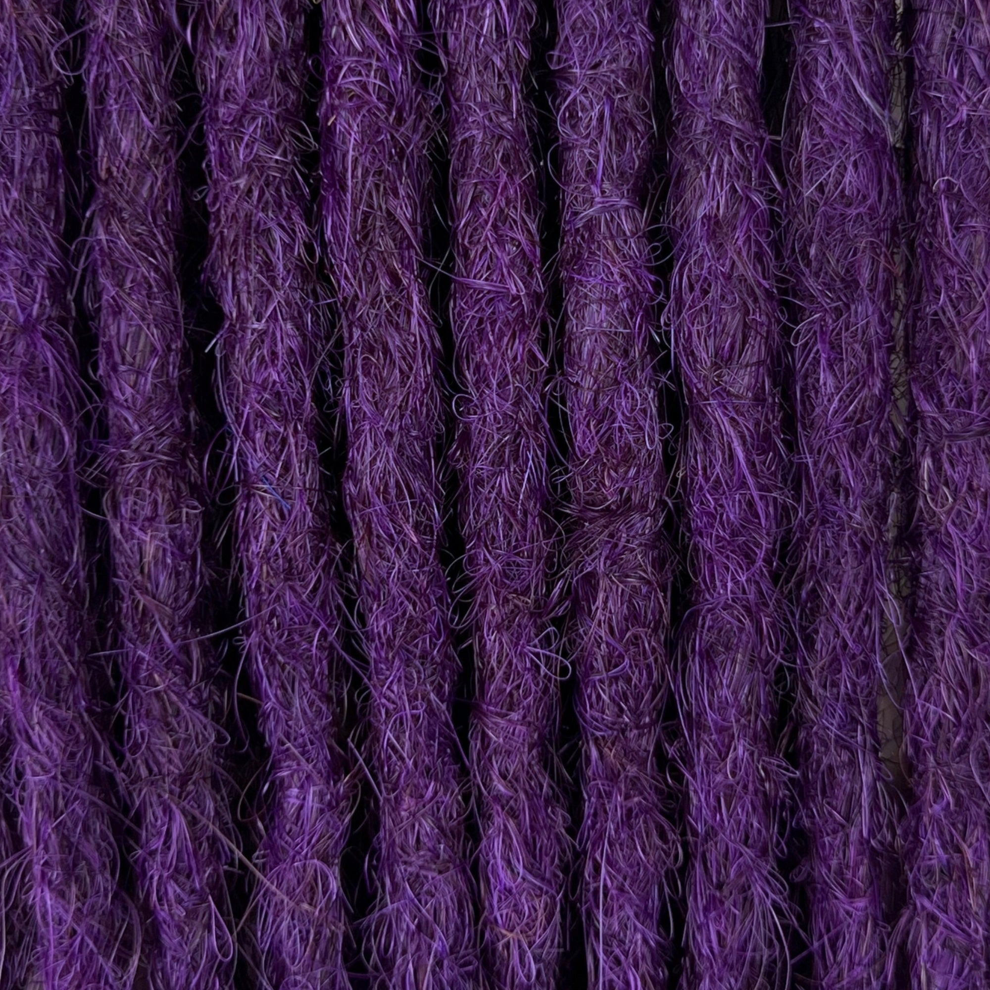 Close-up of straight loc extensions in Electric Violet, showing the texture and color.