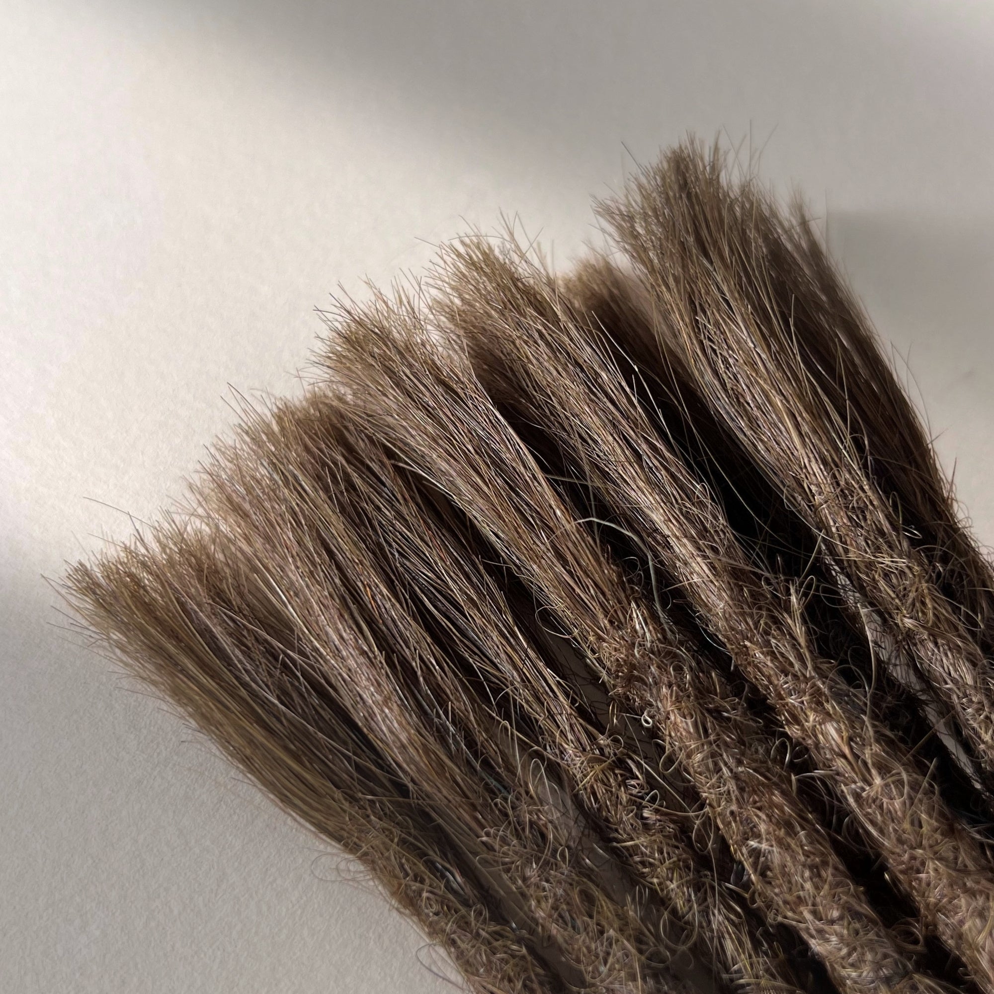 Connection point of permanent straight loc extensions in Medium Brown.