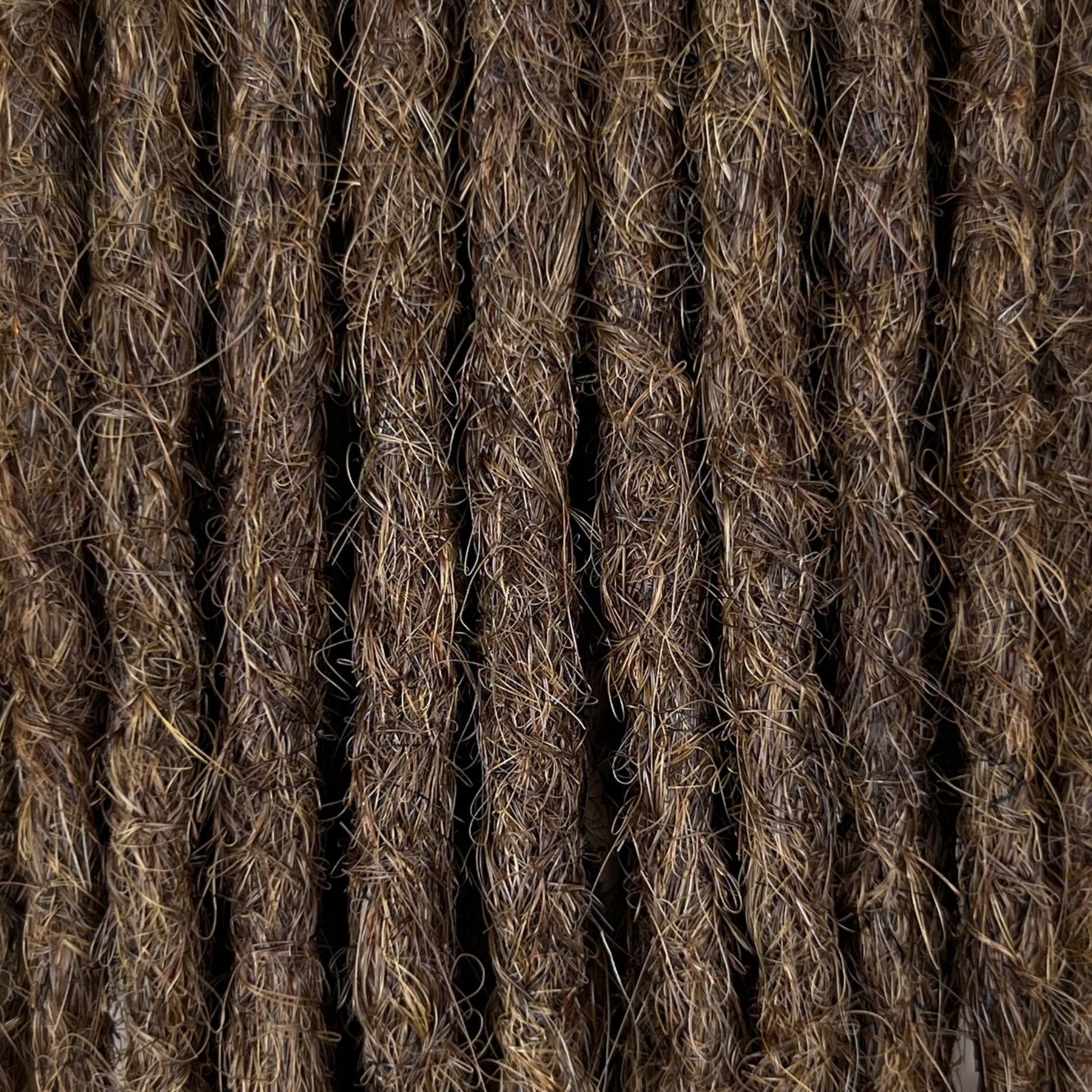 Close-up of straight loc extensions in Medium Brown, showing the texture and color.