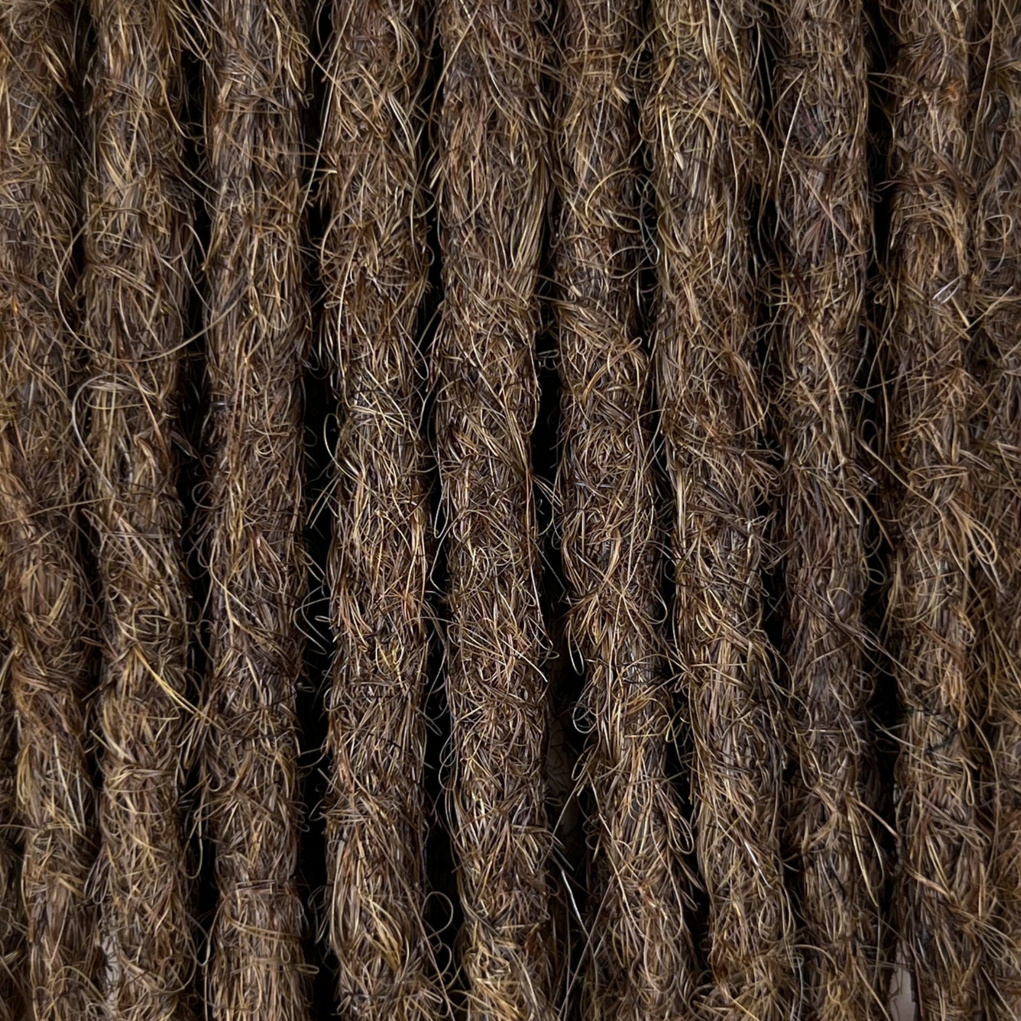 Close-up of straight loc extensions in Medium Brown, showing the texture and color.
