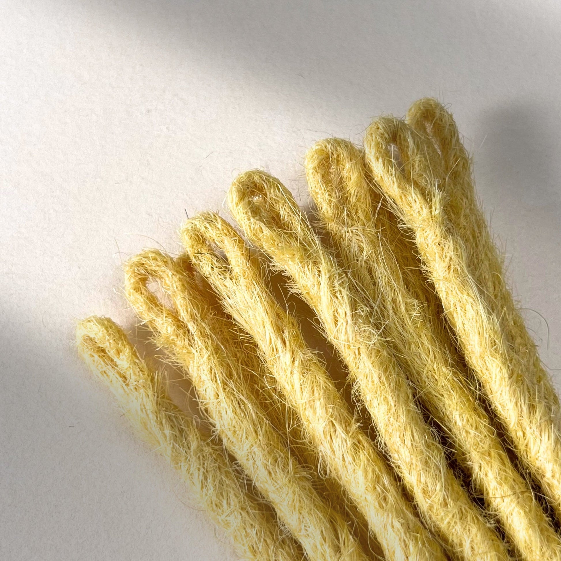 Loop detail of temporary single-ended straight loc extensions in Soft Ochre.